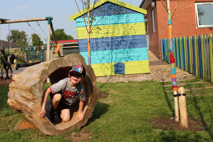 Play tunnel from hollowed tree and colourful beach hut play shed